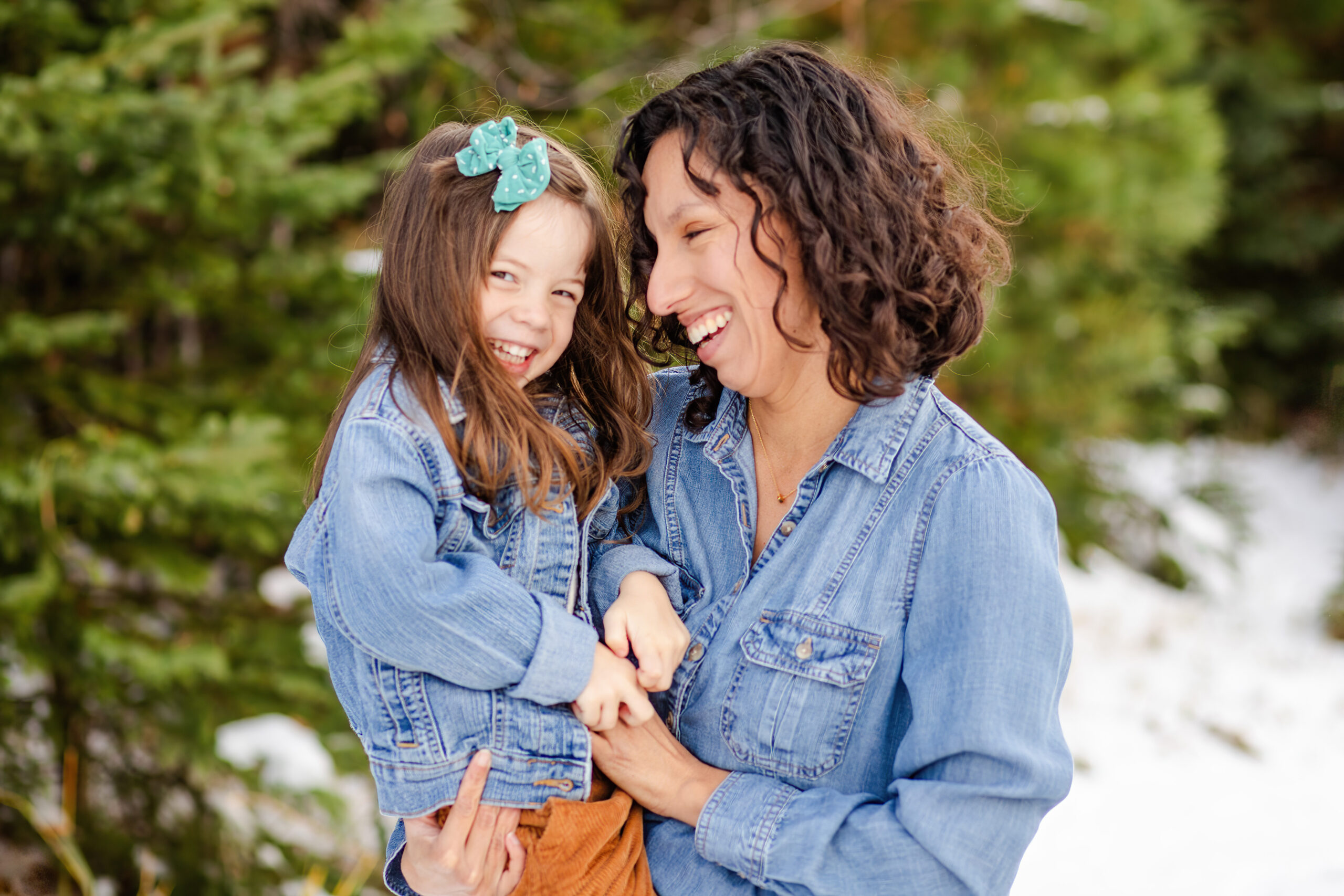 mom and daughter giggling and tickling eaching