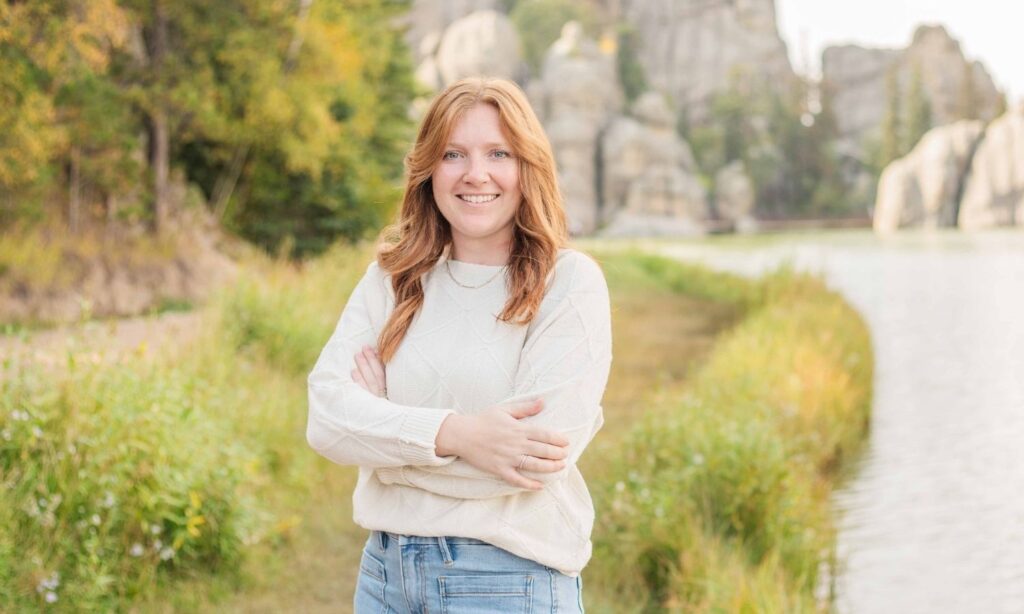Sylvan Lake South Dakota senior style portrait with the Black Hills beauty behind her